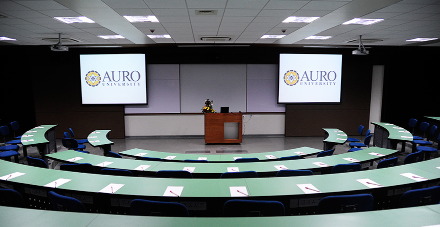 Conference hall interior at AURO University with committee seating